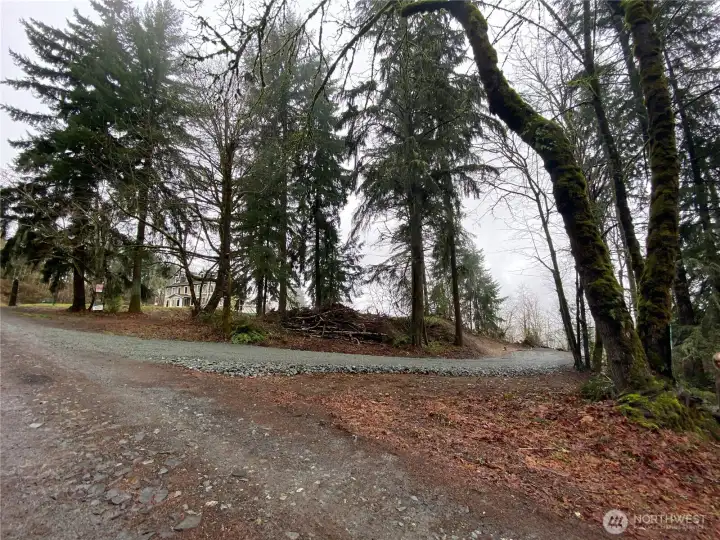 Gravel on the North side of the property. See proximity of the neighbor to the South. Photo taken when freshly cleared.