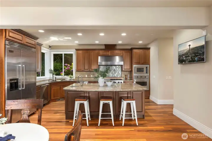 Spacious "chef's" kitchen with island and bar.