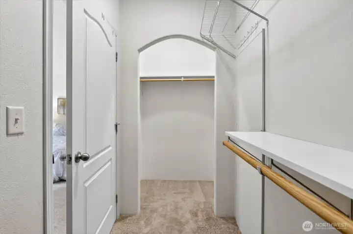 Walk-in closet with built-in storage and clean finishes