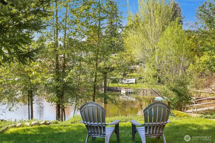 Landscaped yard with mature trees on waterfront