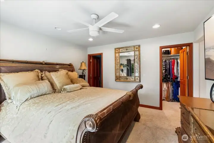 Comfortable primary suite includes plush carpeting and generous walk-in closet.