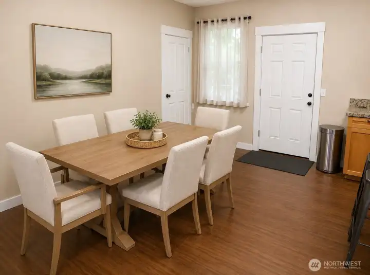 Main-level dining area. Virtually staged.