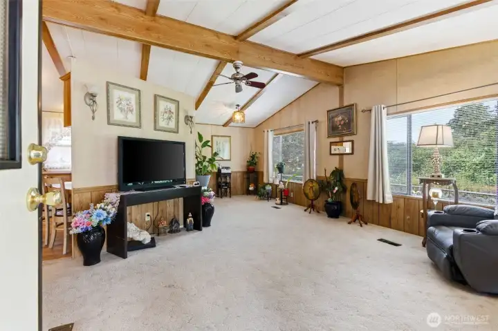 Living Room w/Vaulted Ceilings, Ceiling Fan and adjacent Dining Room