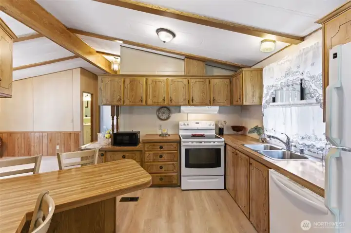 Kitchen with newer Glass Top Electric Range, Dishwasher and Fridge! All stay!