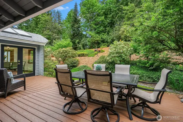 Another view of the generous deck showcases the alfresco dining area and the stunning greenbelt backdrop, making this an exceptional outdoor retreat for warm weather gatherings. Another view of the generous deck showcases the alfresco dining area and the stunning greenbelt backdrop, making this an exceptional outdoor retreat for warm weather gatherings.