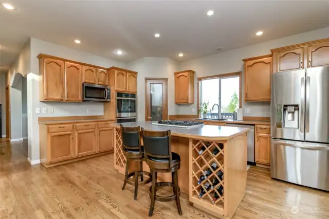 Another view of the kitchen with built-in wine racks.