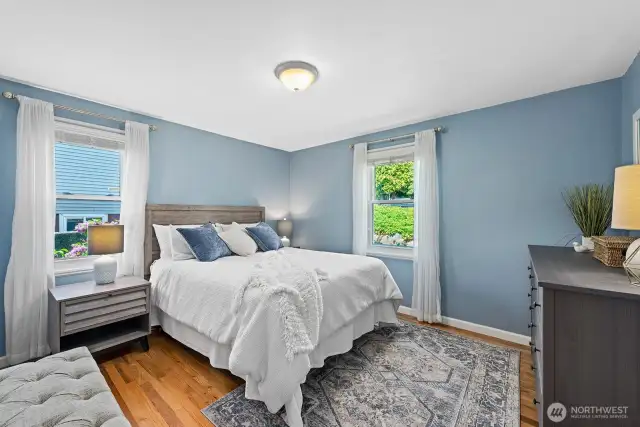 Generous bedroom accommodates a queen bed and large dresser.