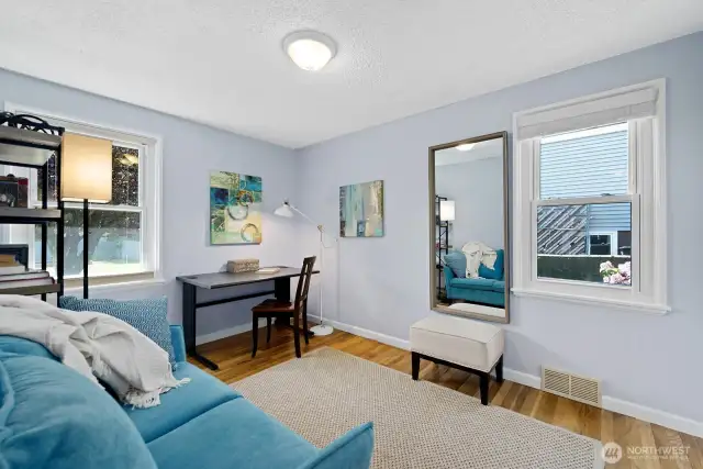 The smaller bedroom, staged as a den, would make a great child's room.