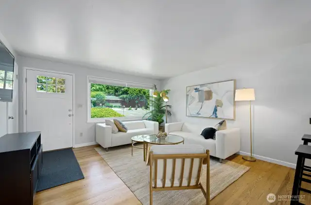 Light filled living room with oak hardwood floors and a redesigned open concept.