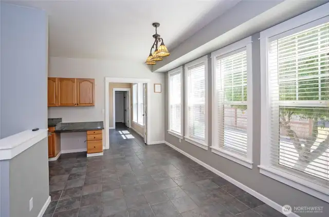 The dining area is elevated by stunning wood-wrapped windows that add warmth and charm.