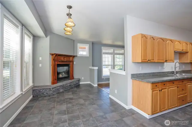 The dining area offers excellent access to the kitchen, and the beautiful lighting adds warmth and ambiance.