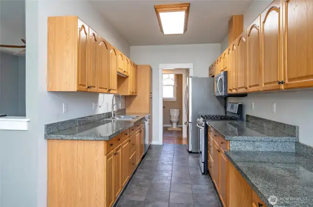 The well-designed galley kitchen provides excellent counter space and plentiful cabinets for maximum functionality.