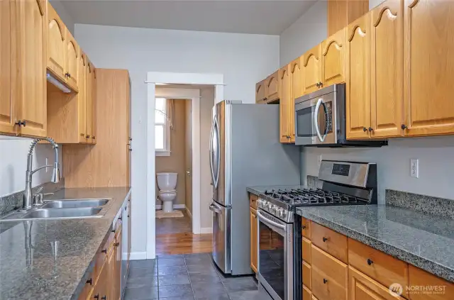Stylish granite surfaces elevate the kitchen with a clean, upscale look.