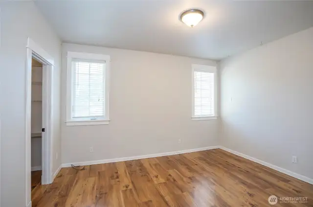 This additional angle showcases the size and warmth of the main-level primary suite.