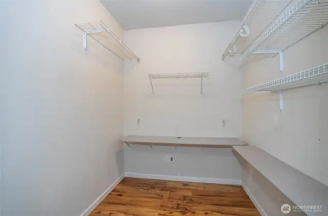 Organized and roomy walk-in closet in the primary suite.