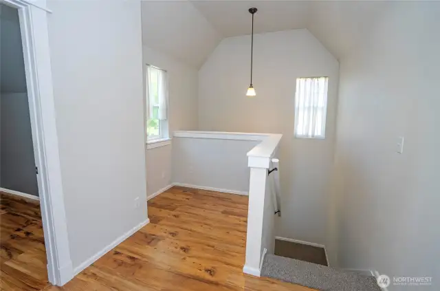 The upper landing provides access to two guest suites and a shared full bathroom.