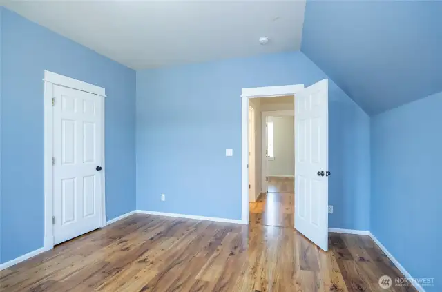 A second look at Guest Suite #1 on the upper level showcases its inviting design.