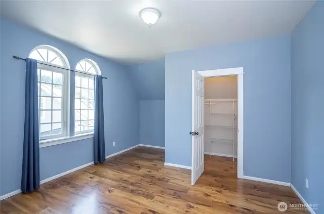 Upper-level Guest Bedroom #1 offers added convenience with a walk-in closet.