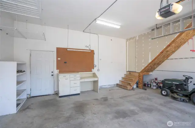 In the garage, the left-hand door opens to the utility room, and the stairway to the right leads to the bonus room over the garage.