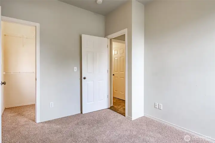 First floor bedroom with walk-in closet with a window.
