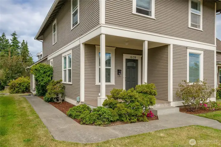Front porch and sidewalk leads to back yard.