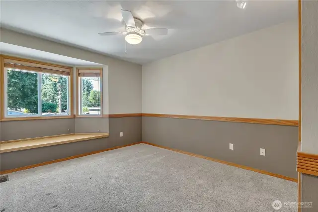 One of the upper level bedrooms, window seating with storage