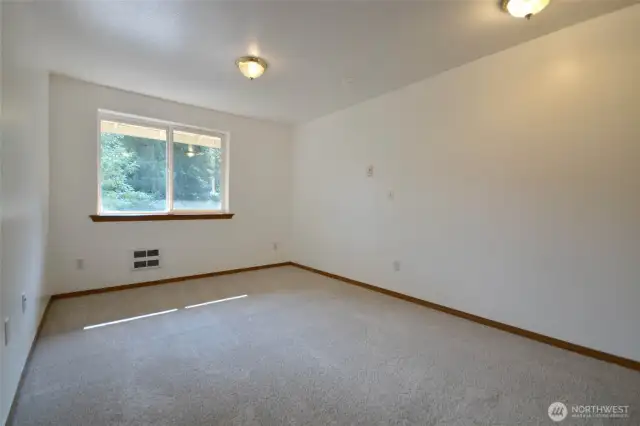 First bedroom. walk-in Closet with closet orginizer and  new carpet 2025.