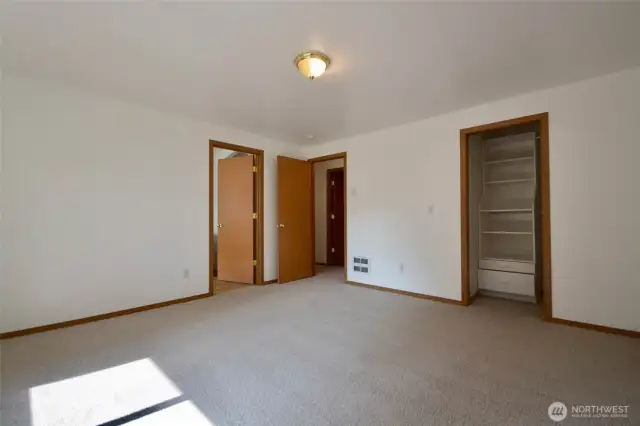 light and bright primary with closet space  and closet organizers and primary bath