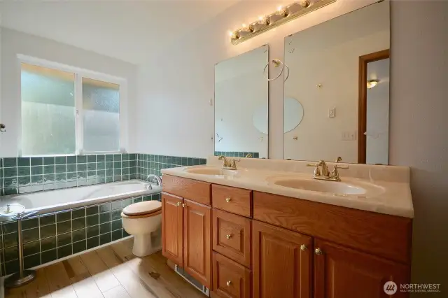 Tiled  jetted tub is perfect for relaxing. Double sinks.