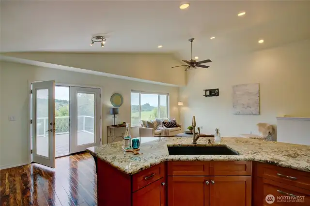 French doors open to spacious great room with vaulted ceilings. Kitchen dining and living all in great central location making it a great place to entertain.