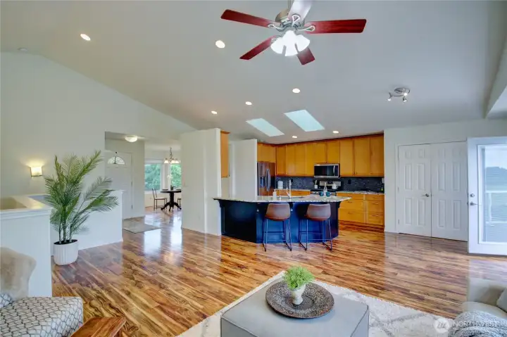 Living room looking towards entry, kitchen and dining area.