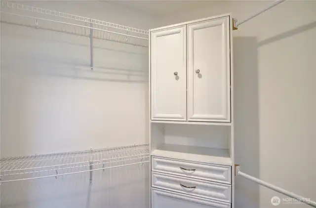 Spacious closet with closet unit.