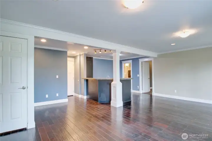 Bonus room looking toward Kitchenette, storage room, bathroom and 5th bedroom/ additional primary bedroom.