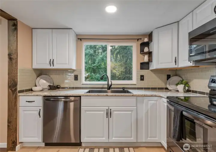 Upgraded kitchen with granite counters, upgraded appliances and new flooring. All appliances stay with the home.