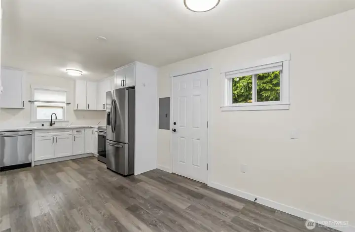 Dining area off the kitchen, view of the back door. Easy access to backyard
