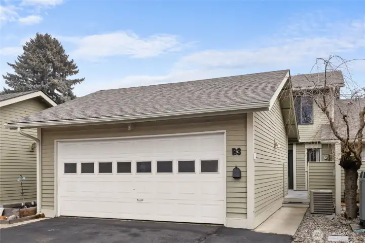A two car attached garage provides covered parking and storage/workspace.