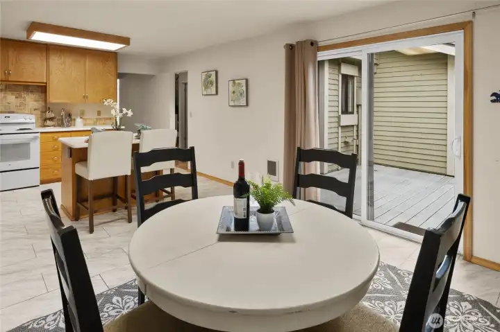 Sliding glass doors lead from the information dining area to the enclosed deck.