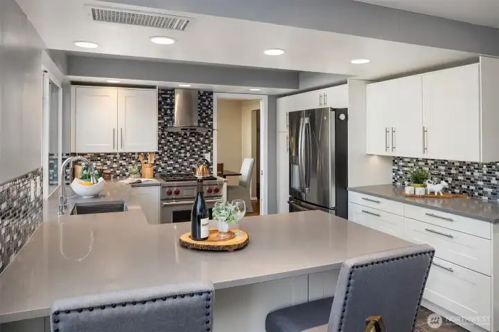 Another look at the remodeled kitchen and all of its storage, including pantry with pull out shelves and counter space - wow!