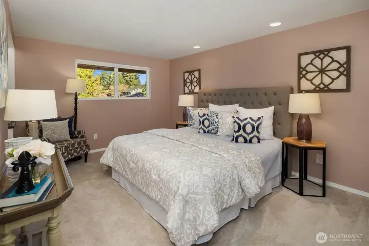 The primary suite overlooks the backyard and includes an attached bath and walk-in closet; all four bedrooms are located together on the upper level. Hardwood floors are located beneath the new (2025) carpet throughout the upper level.