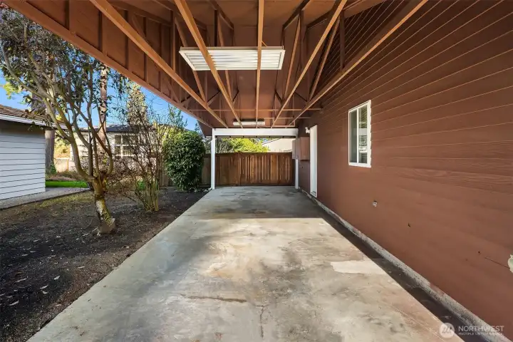 Covered, deep RV/trailer/boat parking with an EV-ready outlet. An additional EV-ready outlet is located in the garage.