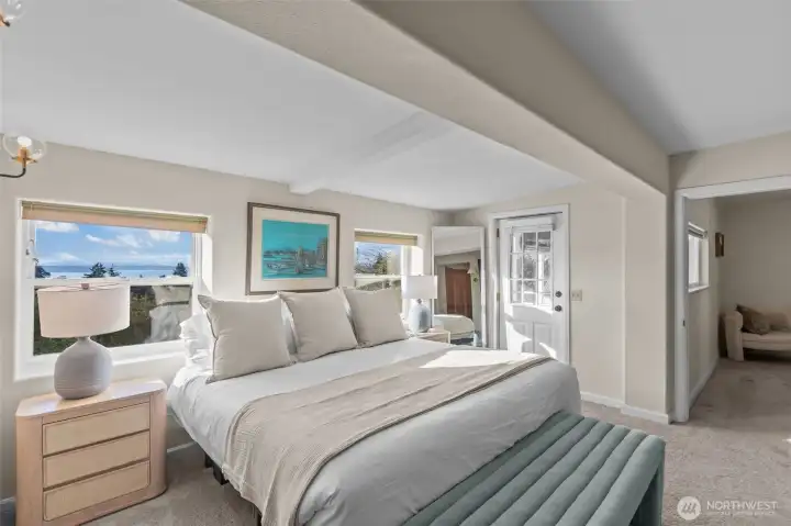 Primary suite with fireplace, ensuite bath, walk-in closet, and laundry