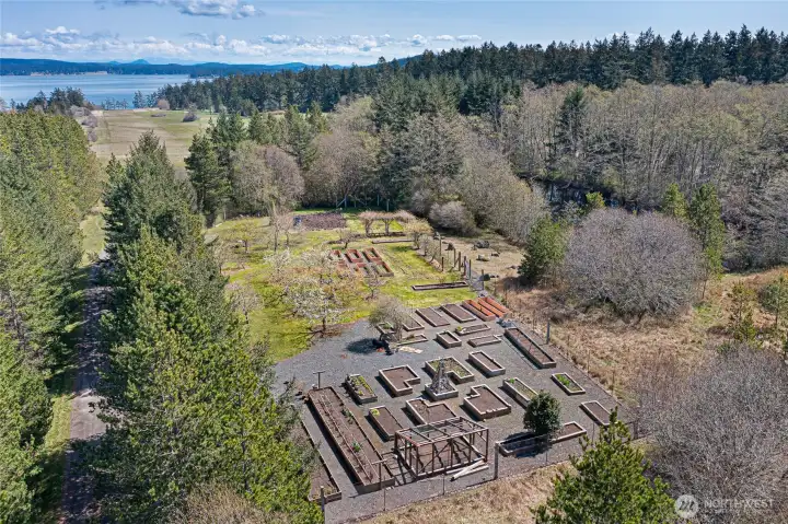 Established gardens and raised beds create a productive and picturesque setting, complementing the estate’s orchards, open fields, and sustainable island lifestyle.