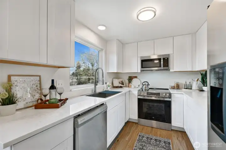 New kitchen!  Cabinets, Quartz countertops, microwave, range and dishwasher all recently installed.