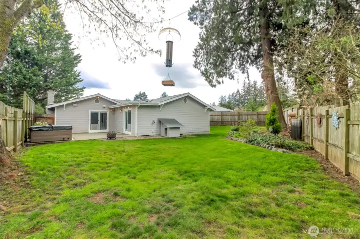 The large private lot is fully fenced and features a dog house, hot tub and firepit!