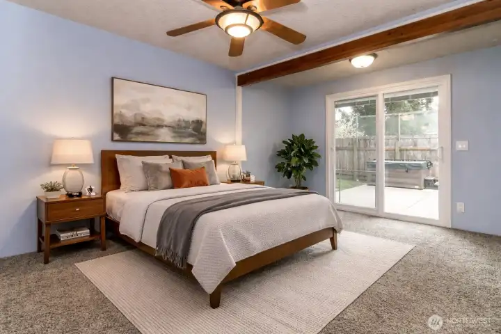 Enjoy the primary bedroom retreat!  Includes a sauna and a sliding glass door that opens onto the patio with a hot tub! Virtually staged