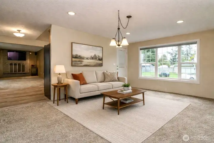 The living room with bay window provides lots of natural light. virtually staged
