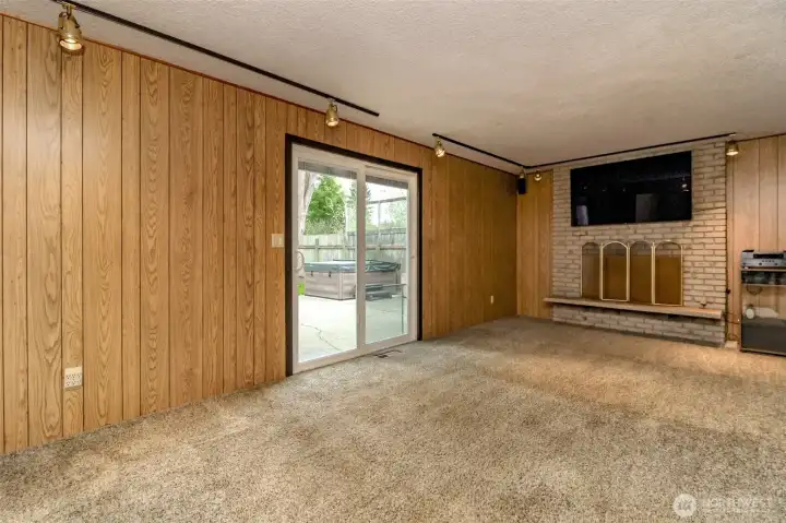 Relax in the family room next to the wood fireplace.  Sliding doors open onto the patio and backyard retreat.