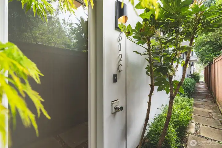 Private, secure entry with individual garage door to the right.