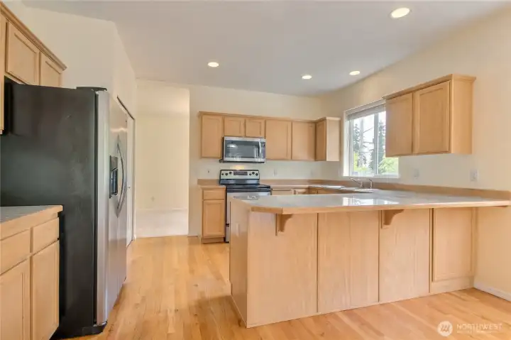 Spacious kitchen has eating bar