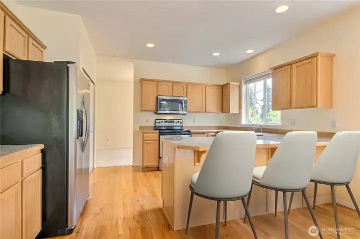 Kitchen has eating bar - virtually staged